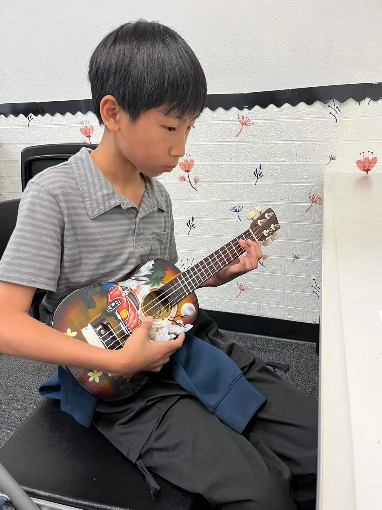 Student playing ukulele